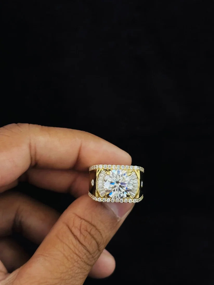 Close-up of a modern iced-out wide band men's wedding ring highlighting the brilliant shine of a round cut central stone