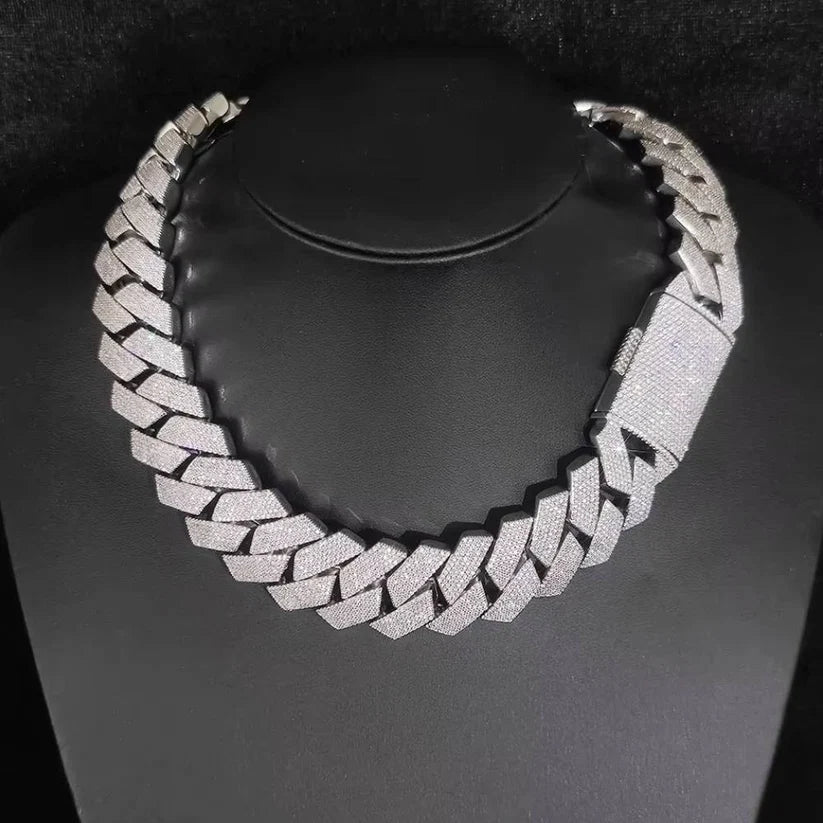 front view of the Iced-out silver Cuban link chain necklace on a black jewelry display bust