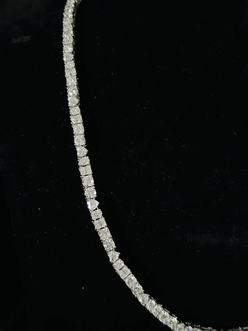 Close-up of a luxury diamond tennis necklace with mixed-cut stones 