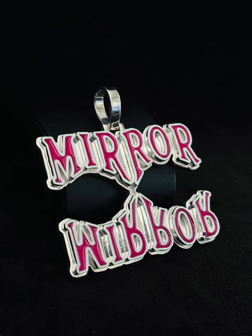 Custom silver Mirror Mirror pendant with pink enamel.