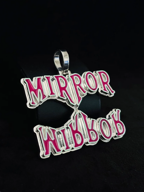 Custom silver Mirror Mirror pendant with pink enamel.