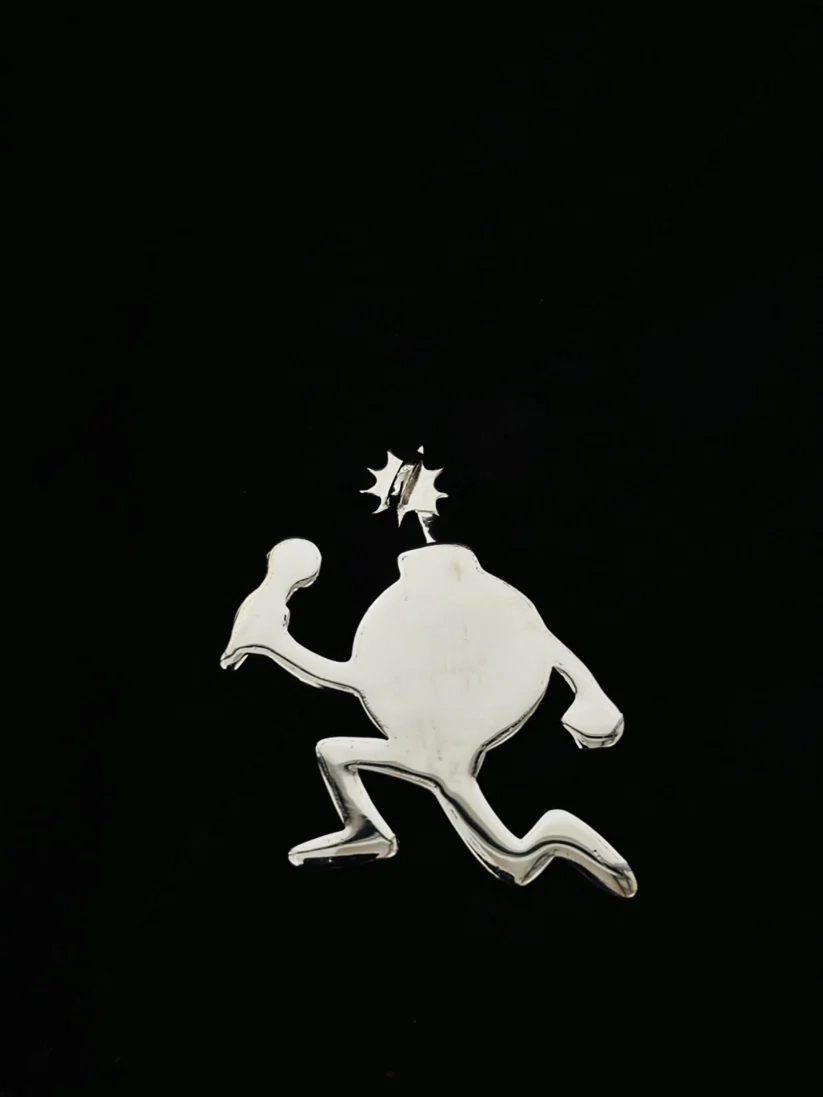 Silver cartoon bomb character pendant running with a lit fuse 