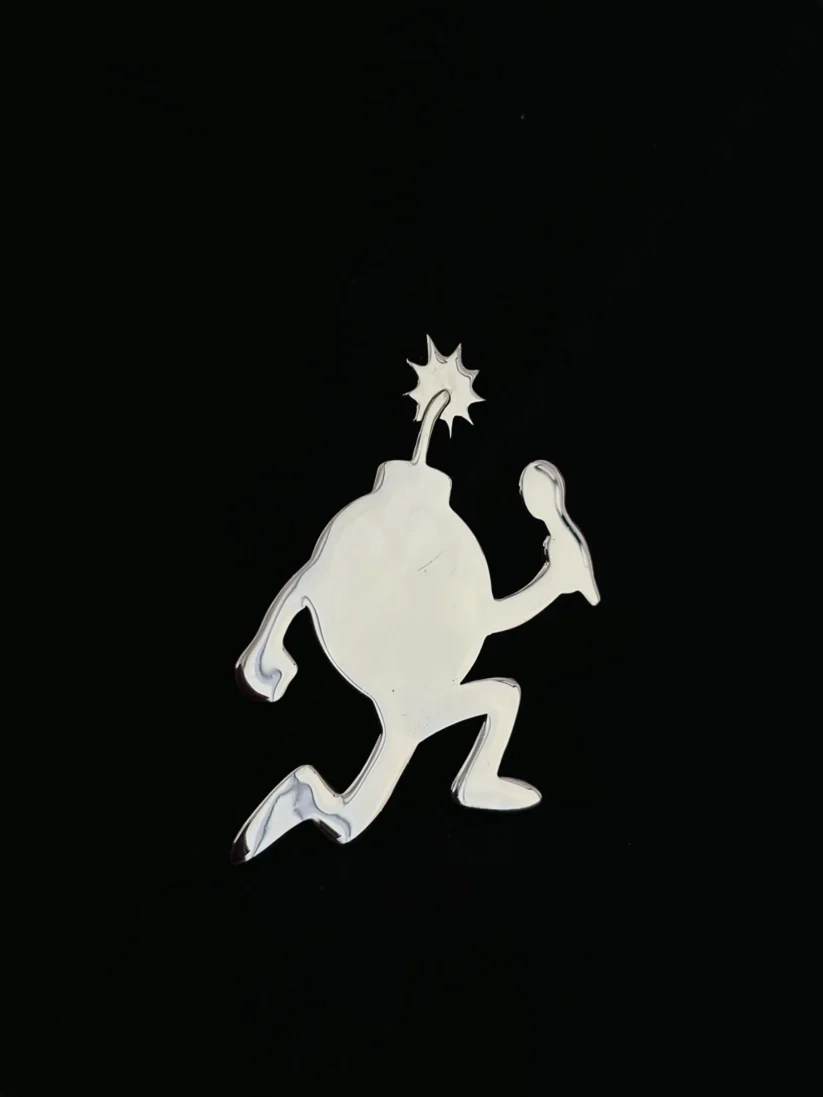 White cartoon running bomb sticker with lit fuse holding a microphone 