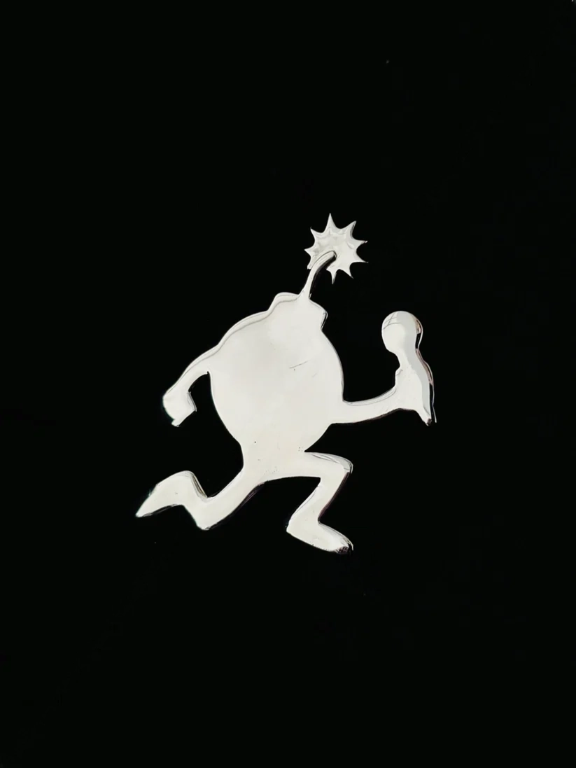 Polished silver cartoon bomb pendant charm with lit fuse holding microphone