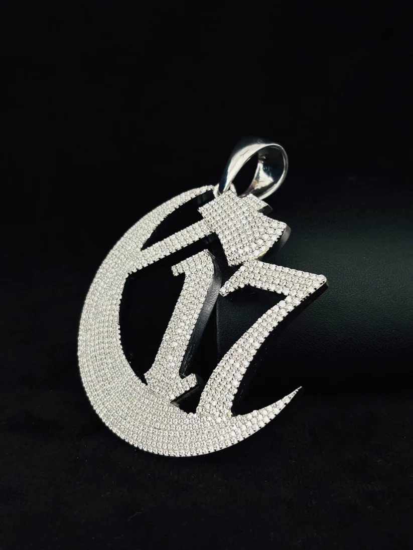 side view C17 crescent moon and hatchet iced out pendant in silver.