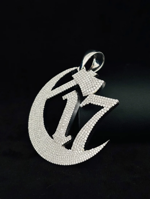 side view C17 crescent moon and hatchet iced out pendant in silver.