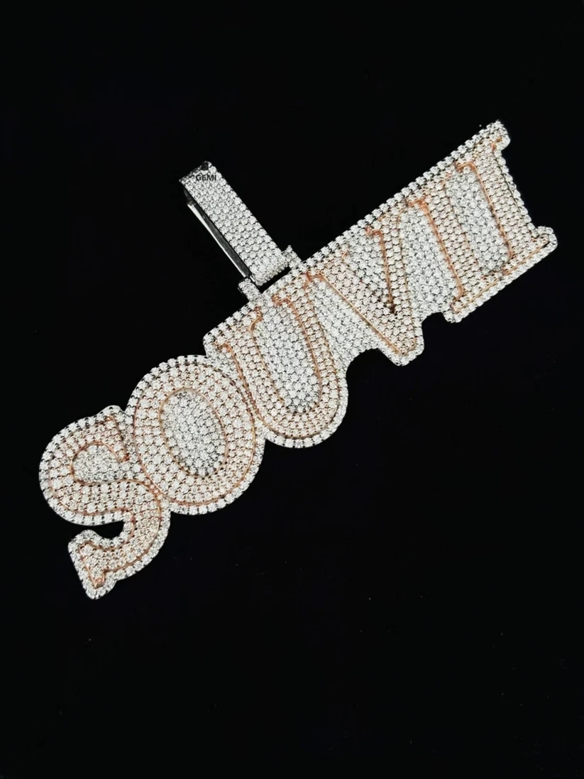 Custom iced-out diamond name pendant spelling SOUVI in two-tone rose gold and white gold.