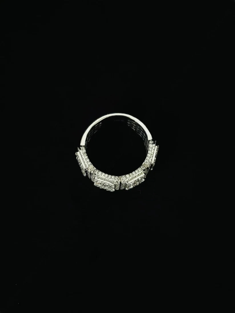 Top-down view of a silver diamond encrusted statement ring with intricate pave settings