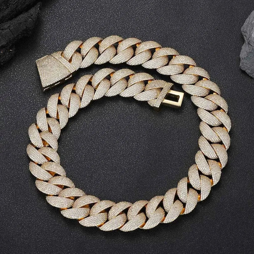 close up of a Gold Cuban link chain necklace iced out with small diamonds
