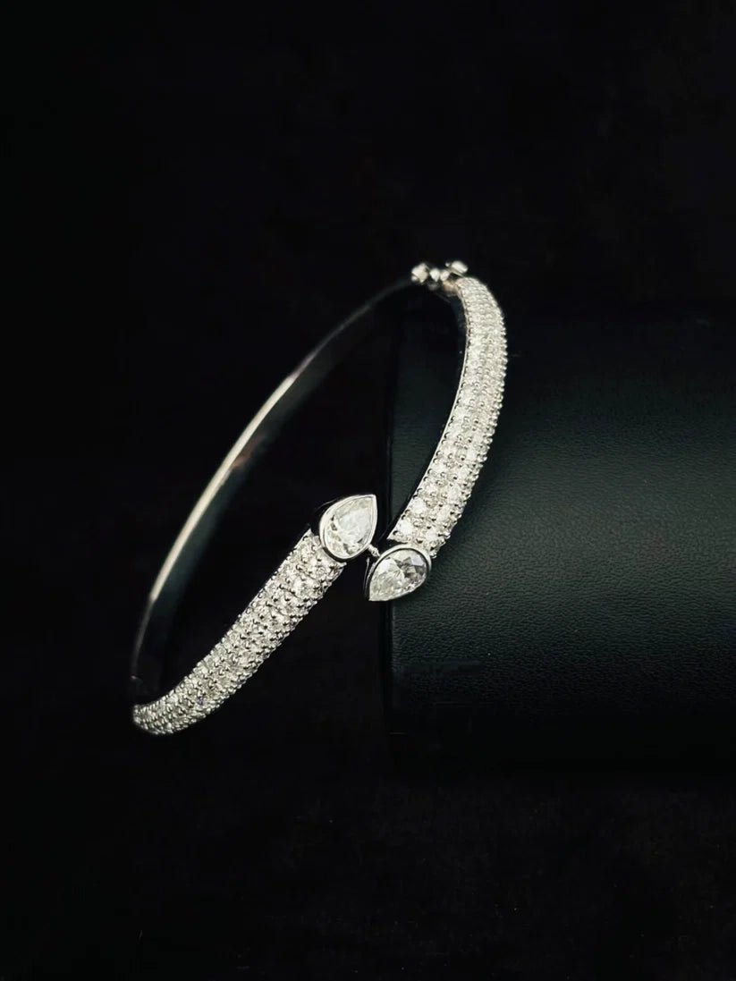 Sterling silver pave diamond bypass bracelet featuring pear-shaped stones