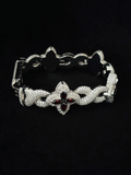 Silver four-leaf clover pave diamond bracelet with red ruby stones