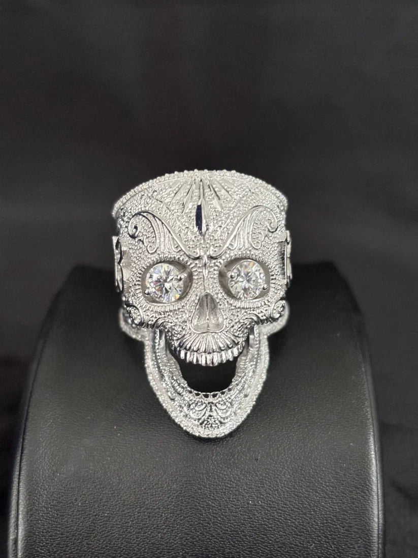 Silver skull ring iced out with pave diamonds and round stone eyes
