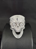 Silver skull ring iced out with pave diamonds and round stone eyes