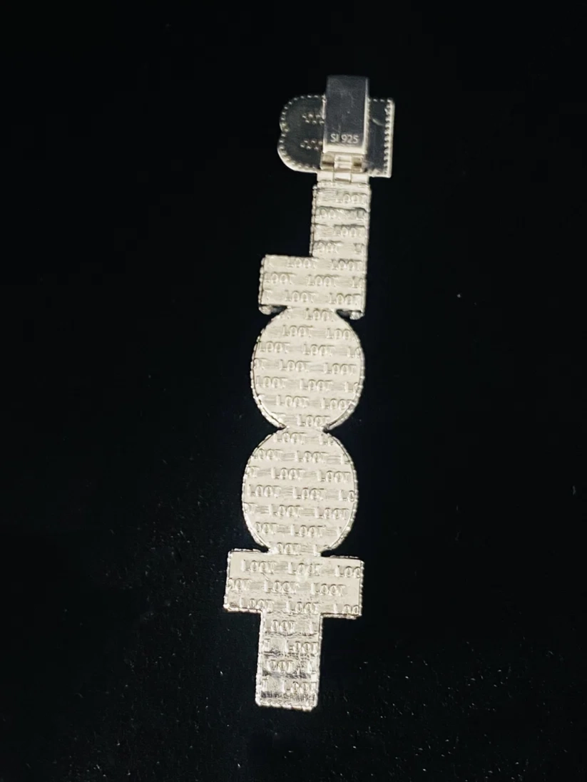 Silver iced-out vertical text pendant against a black background.