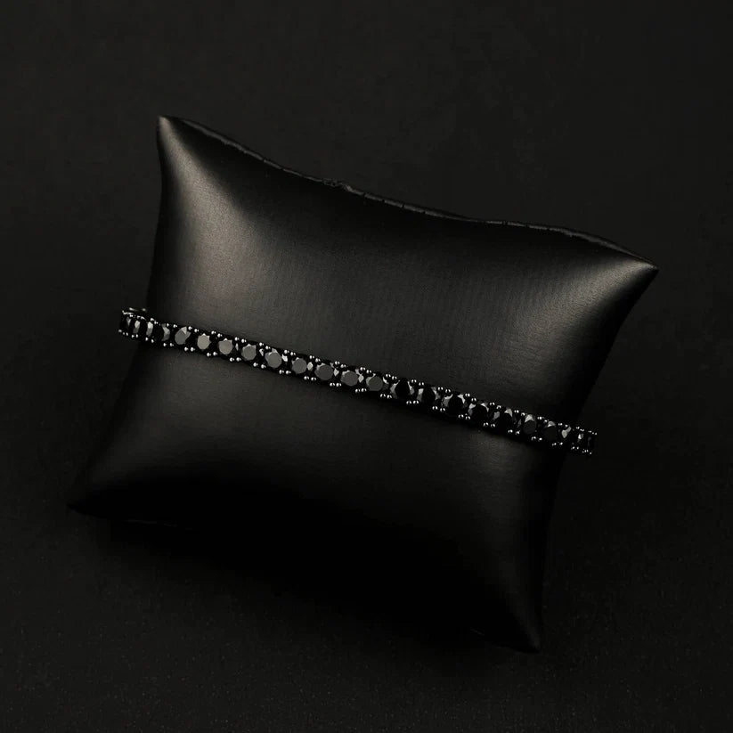 Black diamond tennis bracelet on a black display pillow