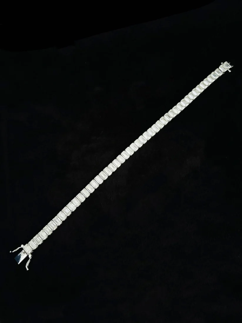 Silver emerald cut tennis bracelet with an integrated box clasp closure
