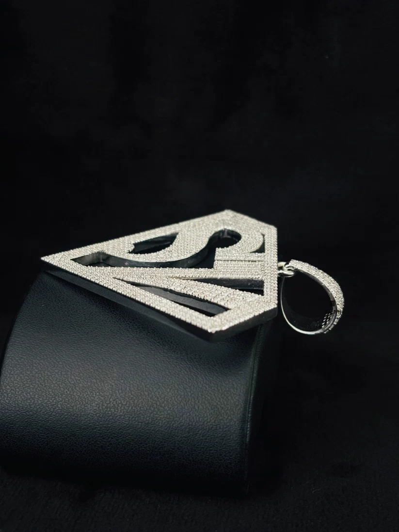 Iced out Superman logo pendant in sterling silver with pave VVS simulated diamonds
