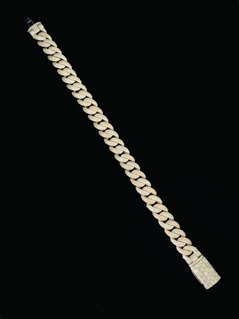 Gold diamond Cuban link chain necklace on a black background