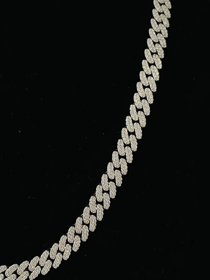 Close-up of a silver diamond Cuban link chain necklace