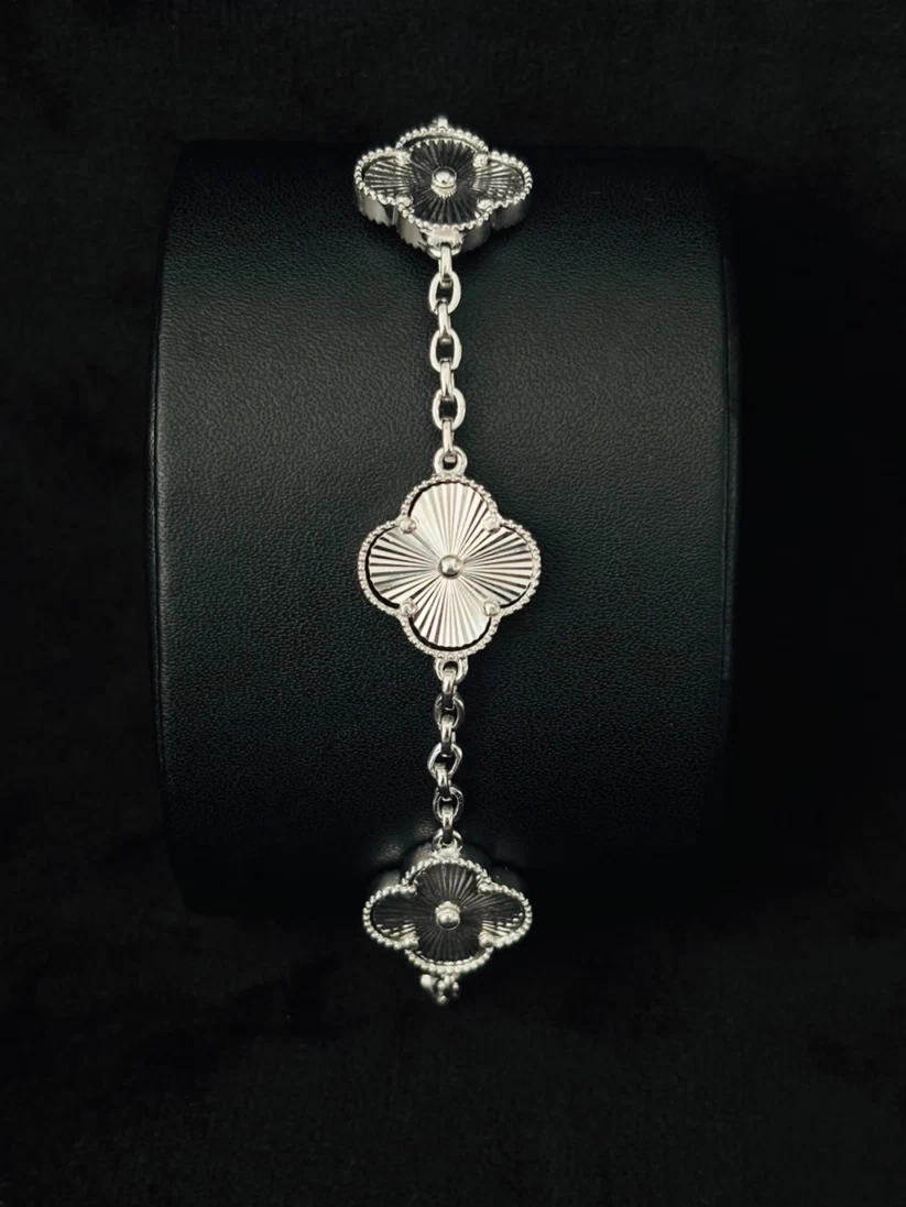 Close-up of a luxury Van Cleef Alhambra bracelet in Silver sunburst engraving