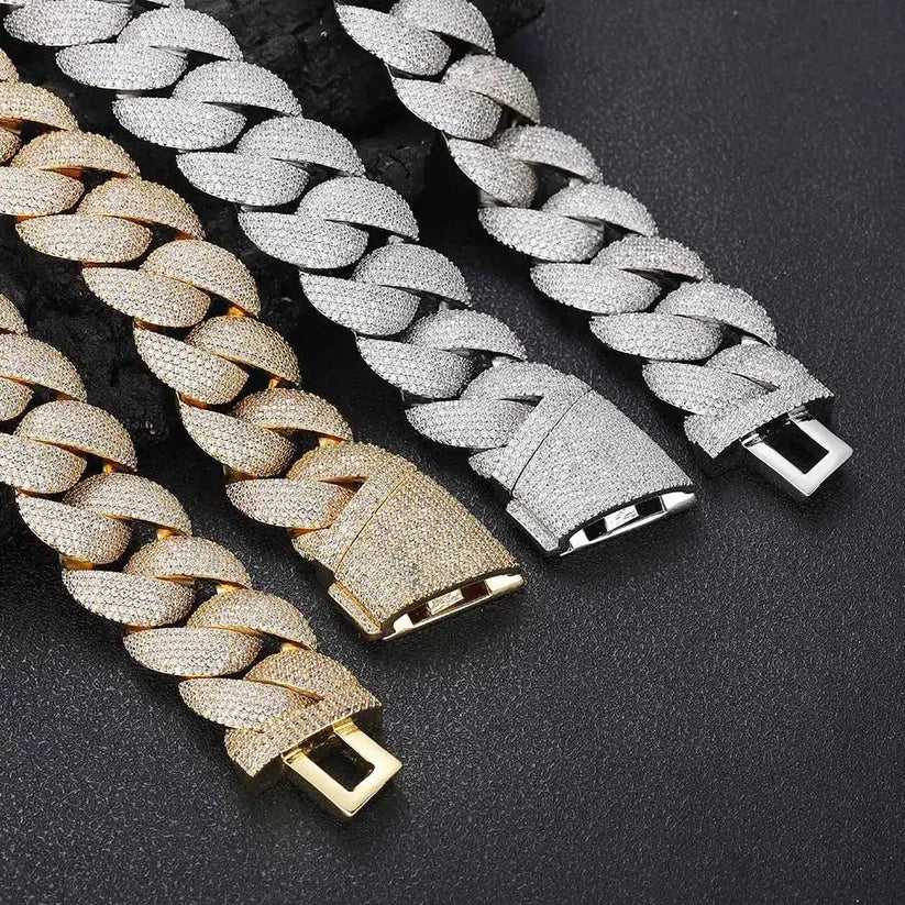 Close-up of three luxury diamond Cuban link bracelets featuring a secure pavé rhinestone clasp