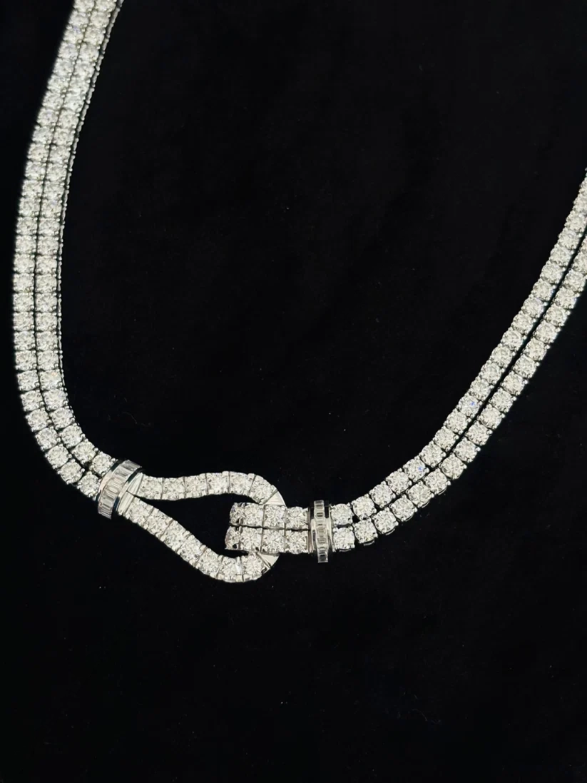 Double-strand diamond tennis necklace with a paved diamond horseshoe buckle clasp