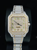 Diamond-set luxury square watch with two-tone gold accents and green Arabic hour markers.