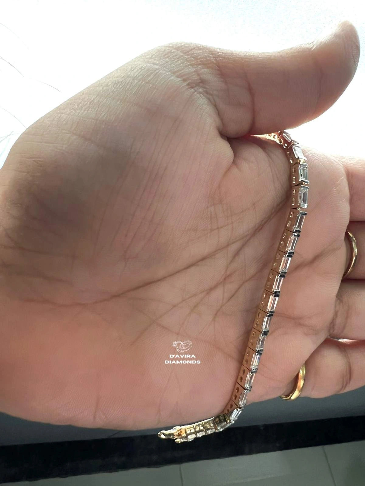 Emerald cut lab grown diamond tennis bracelet on wrist