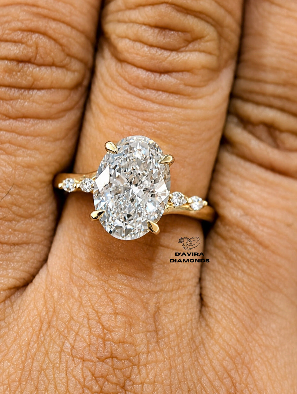 oval-cut diamond ring with gold small side diamonds