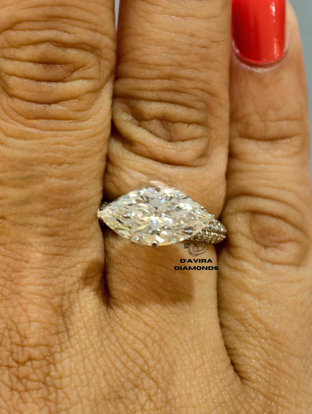 Large marquise cut diamond engagement ring on a finger