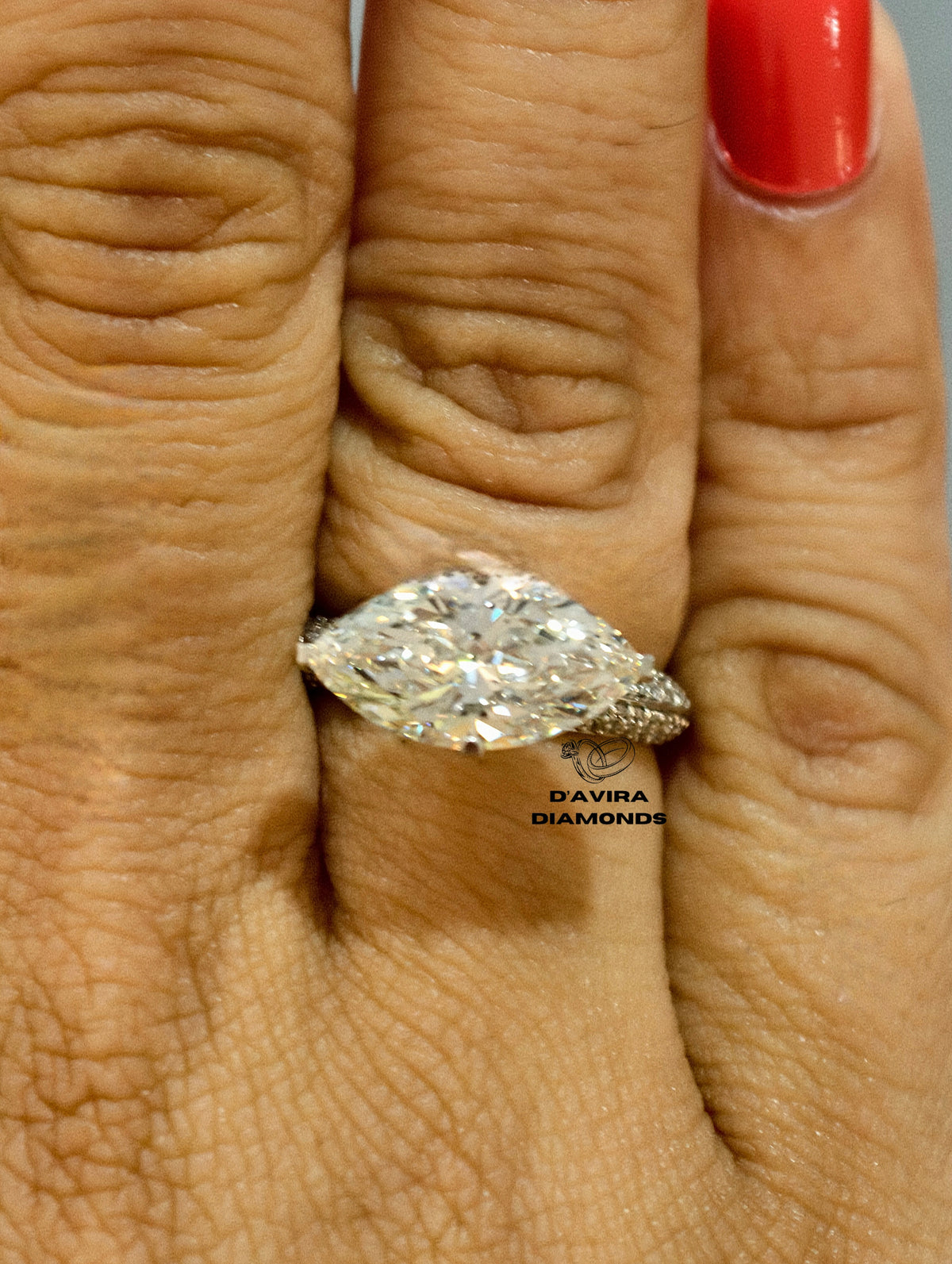 Large marquise cut diamond engagement ring on a finger