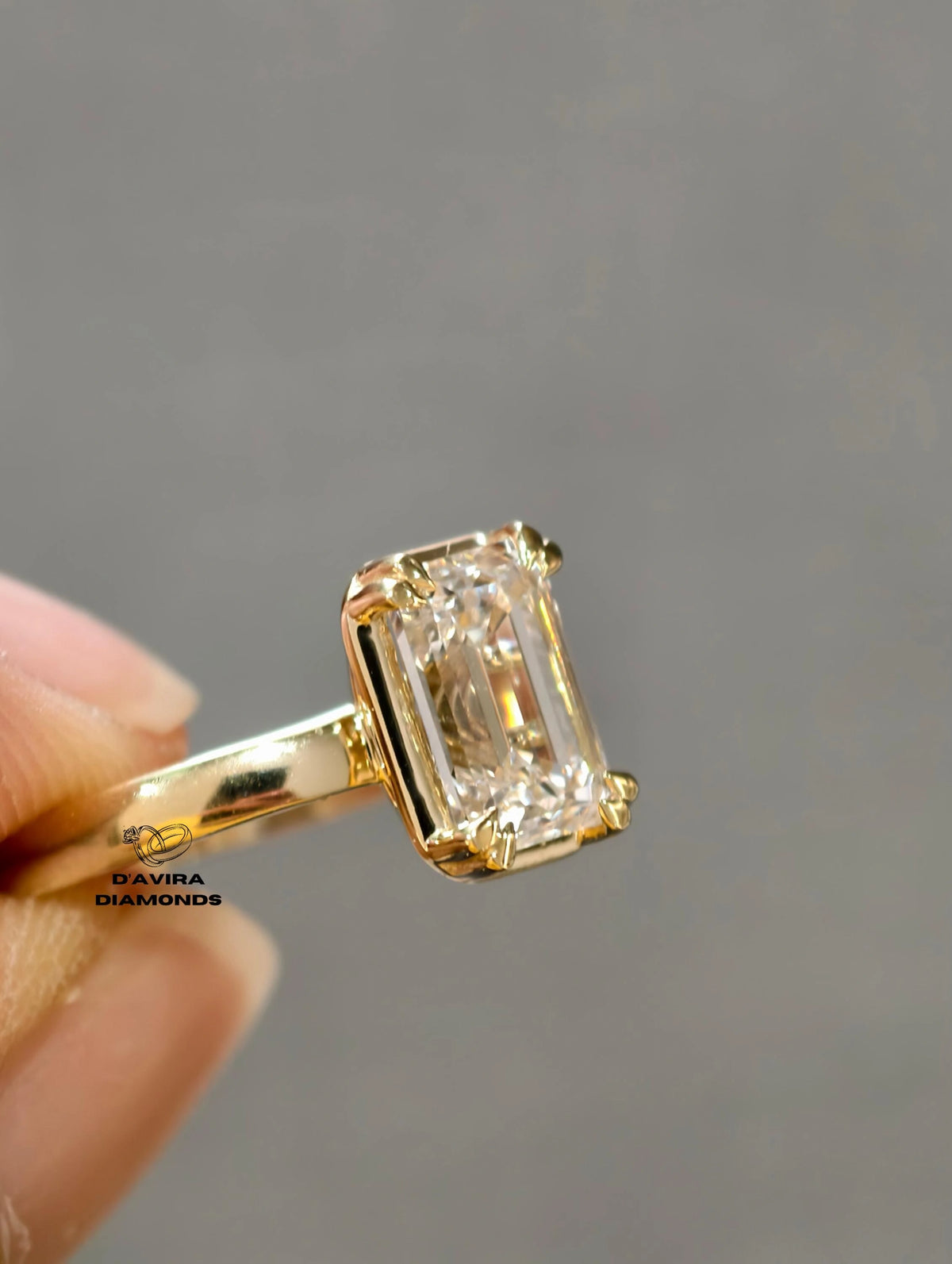 Emerald cut diamond ring with a yellow gold solitaire claw set ring