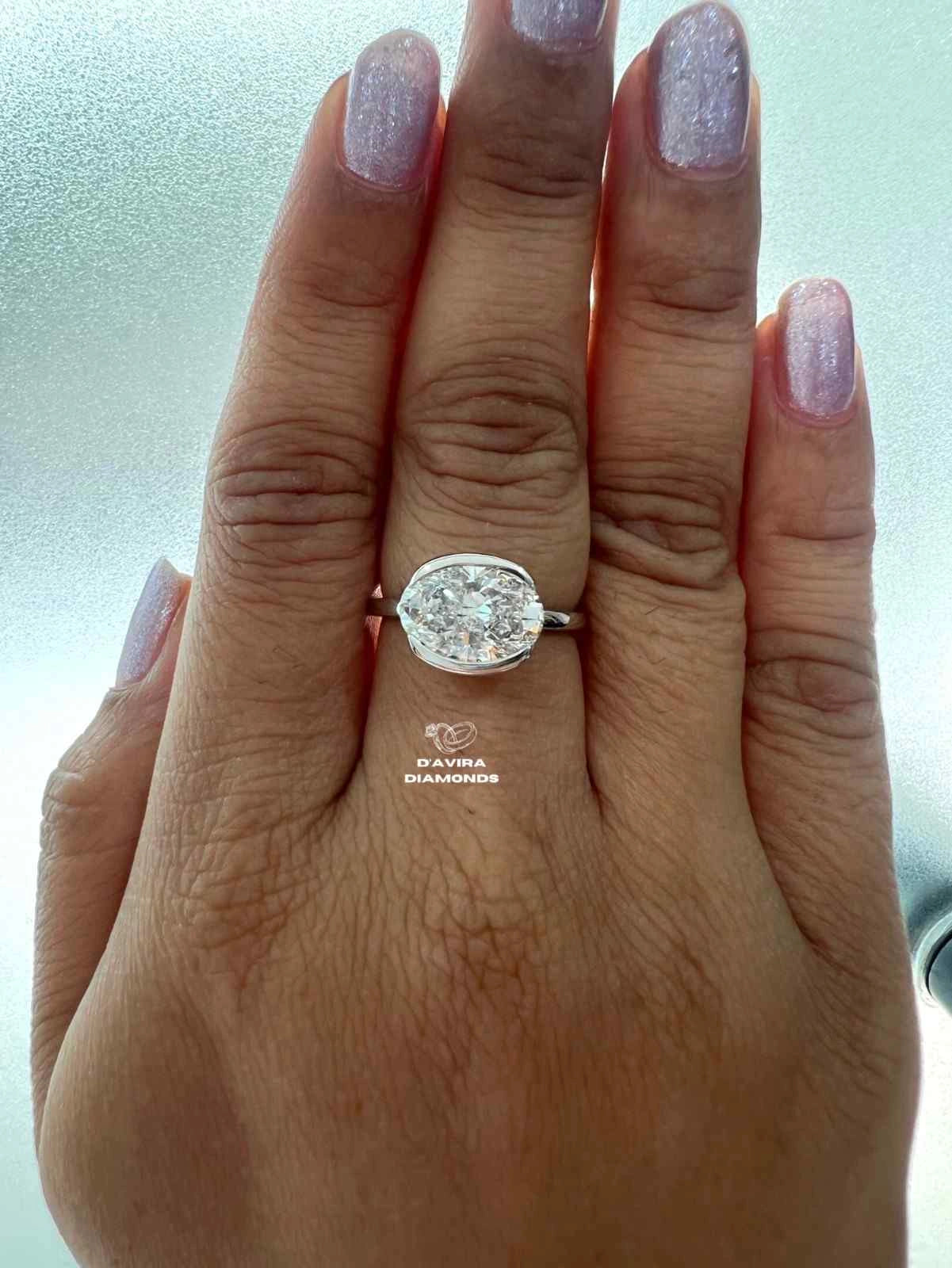 East West Oval Cut Half Bezel Set Diamond Ring