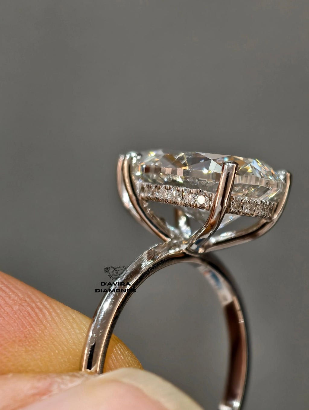 Side profile of a oval lab diamond ring with a hidden halo setting