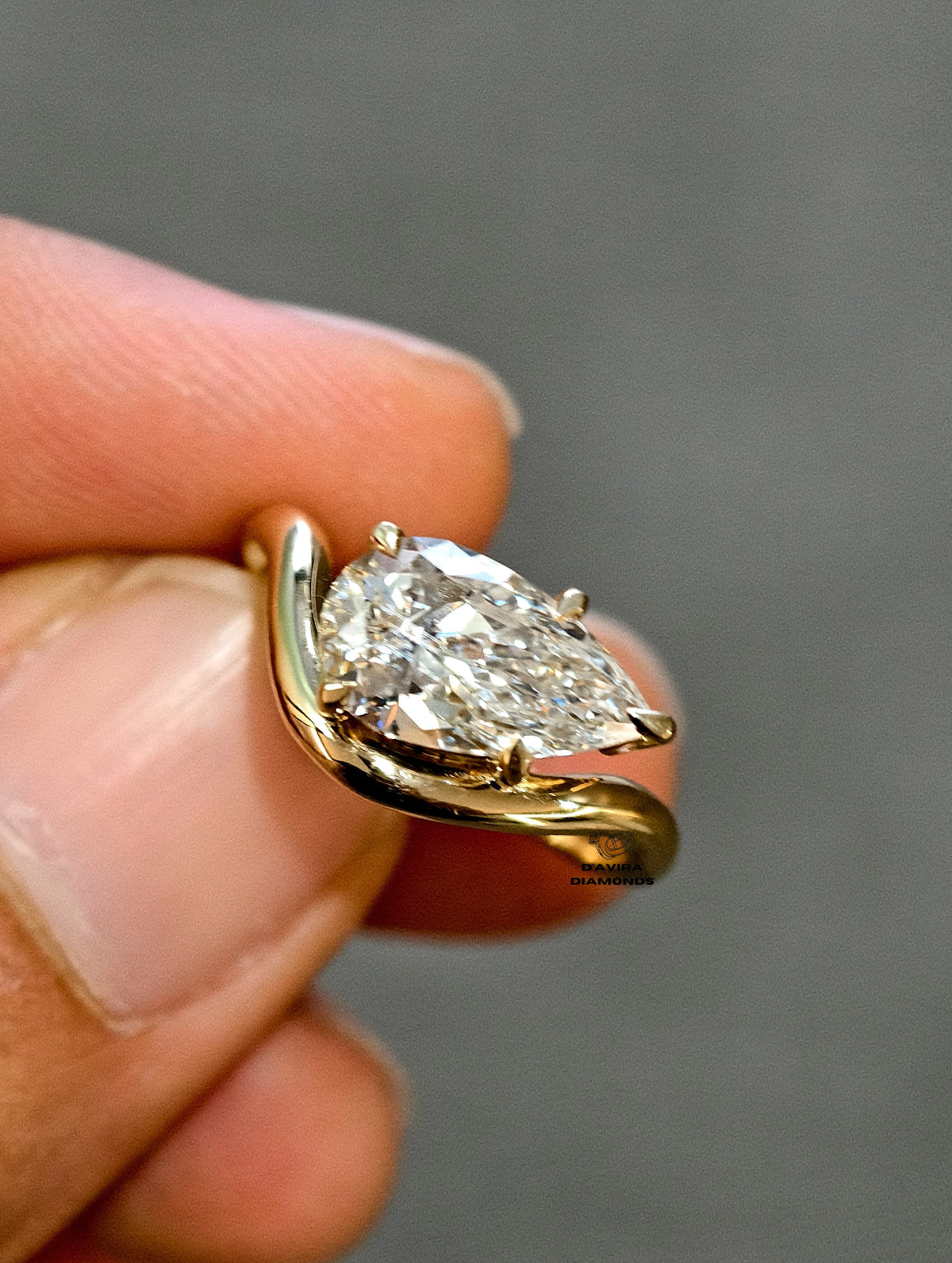 hand holding of horizontal pear cut lab diamond ring