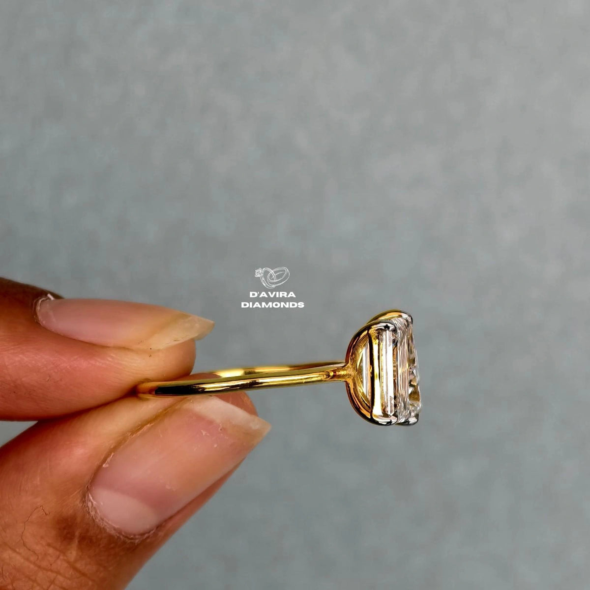 Side view of an emerald cut lab grown diamond wedding ring