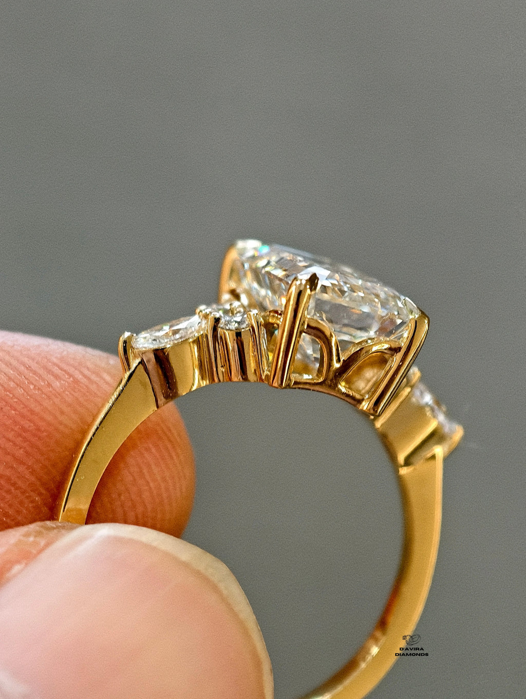 side view yellow gold setting with marquise and round cluster side stones