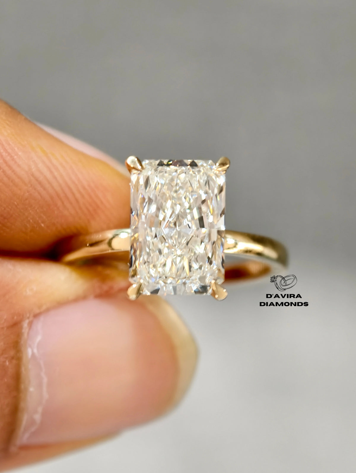 Radiant-cut diamond engagement ring with a gold solitaire band