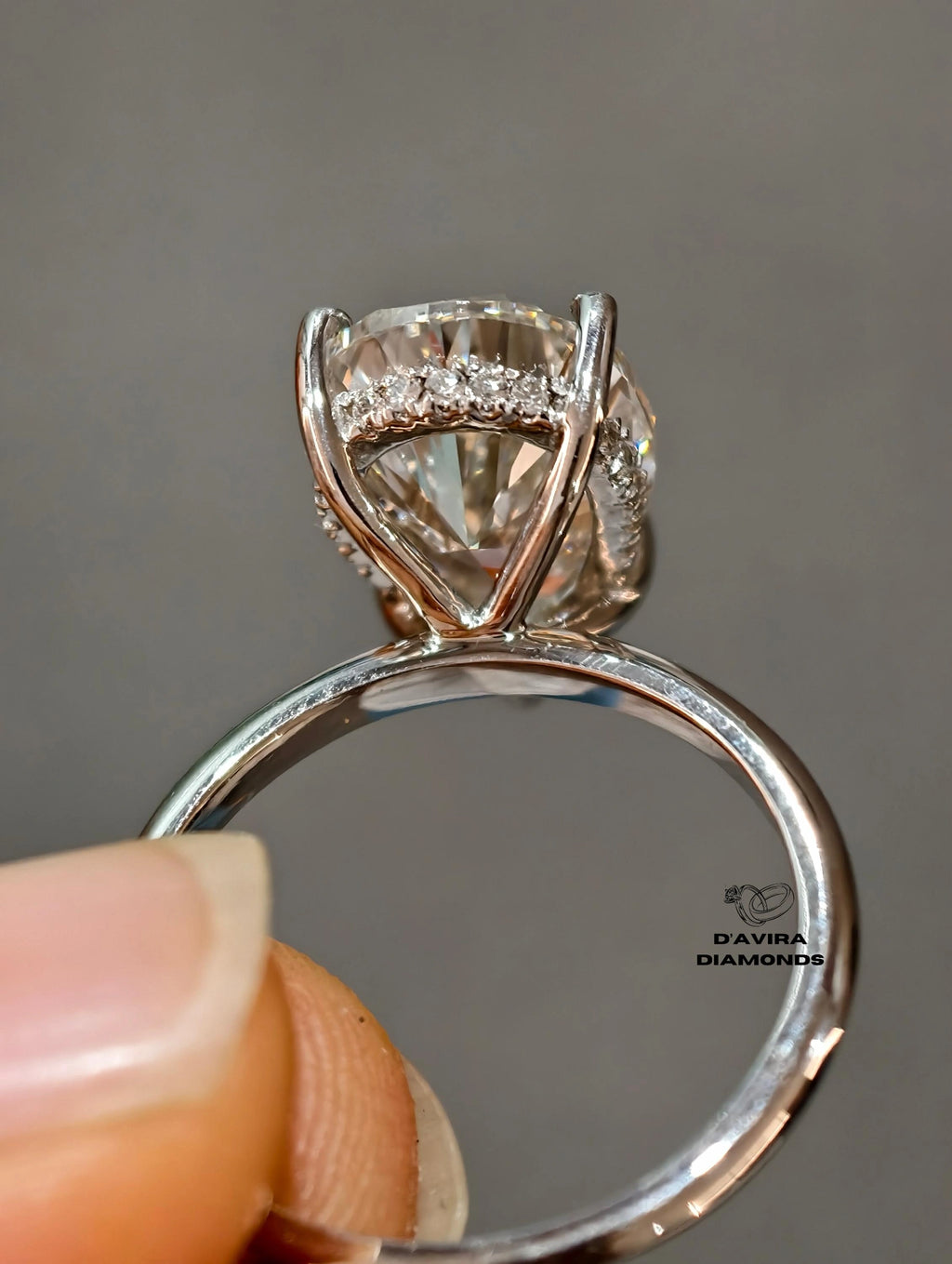 Oval cut diamond ring with a pave diamonds under the center stone