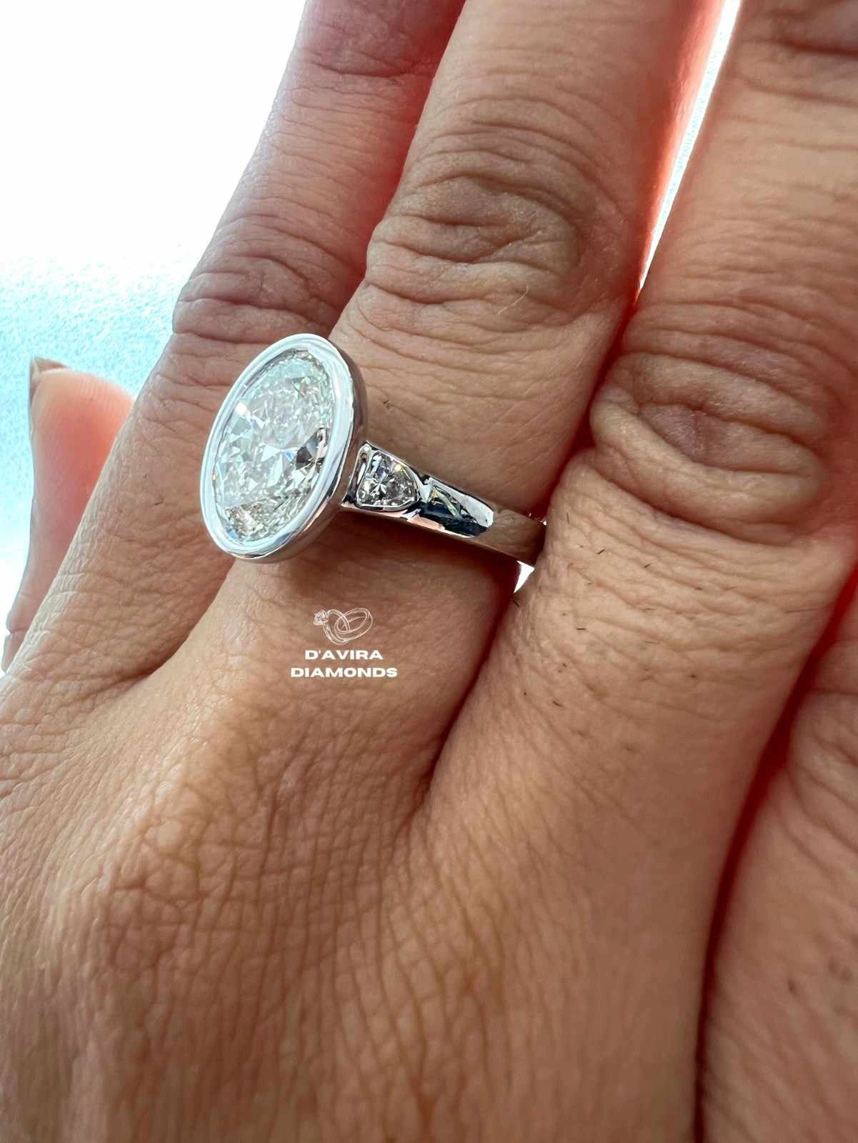 Lab Grown Oval Engagement Ring in Bezel Setting Three Stone style