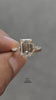 video of  Emerald cut diamond engagement ring with marquise and round side stones