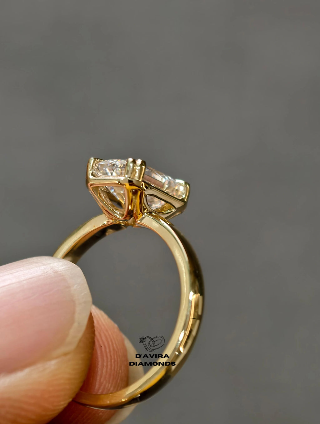 radiant cut diamond ring with a high profile four prong set held by fingers