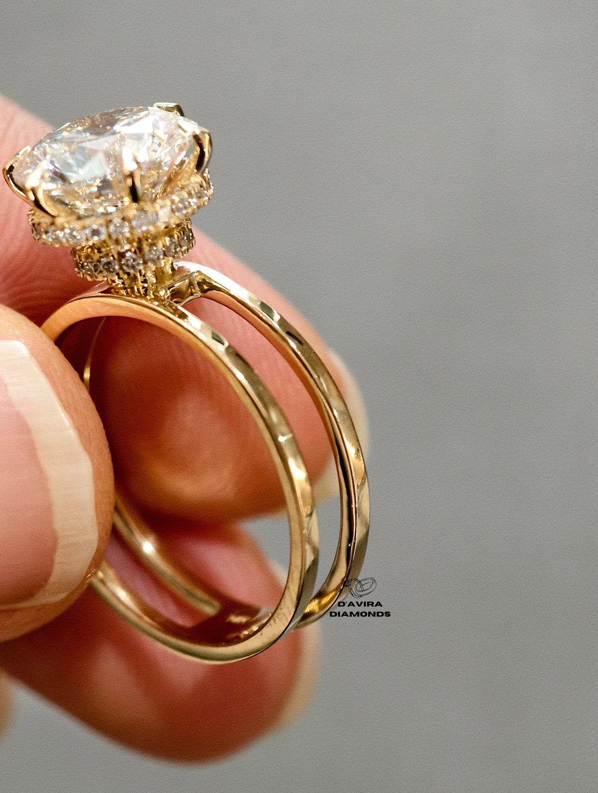round brilliant cut center stone set with prongs above a hidden halo and a double split-shank band.