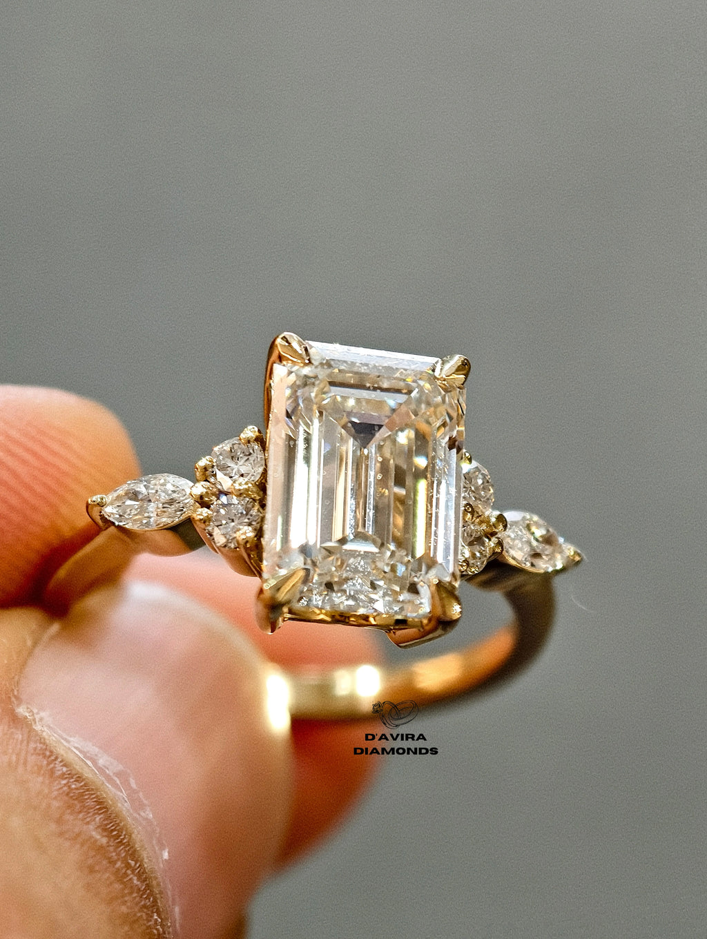  front view of the Emerald-cut diamond  with marquise and round side stones