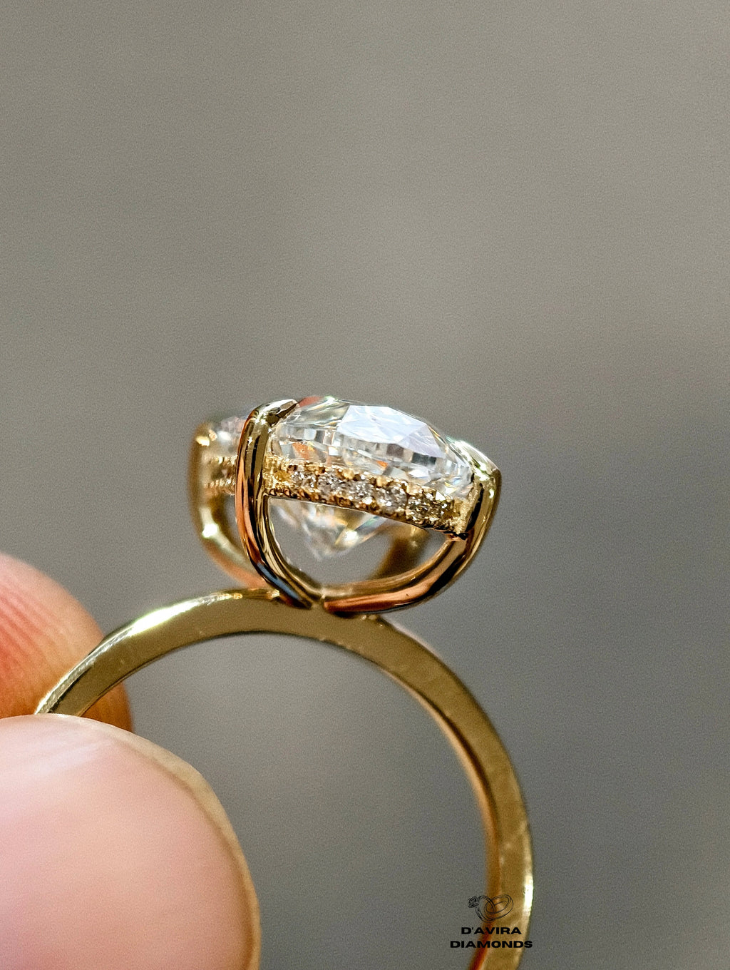 gold band and a hidden diamond pave halo basket setting.