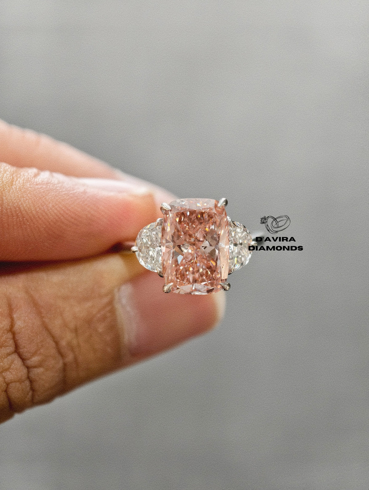 hand holding cushion cut lab diamond wedding ring 